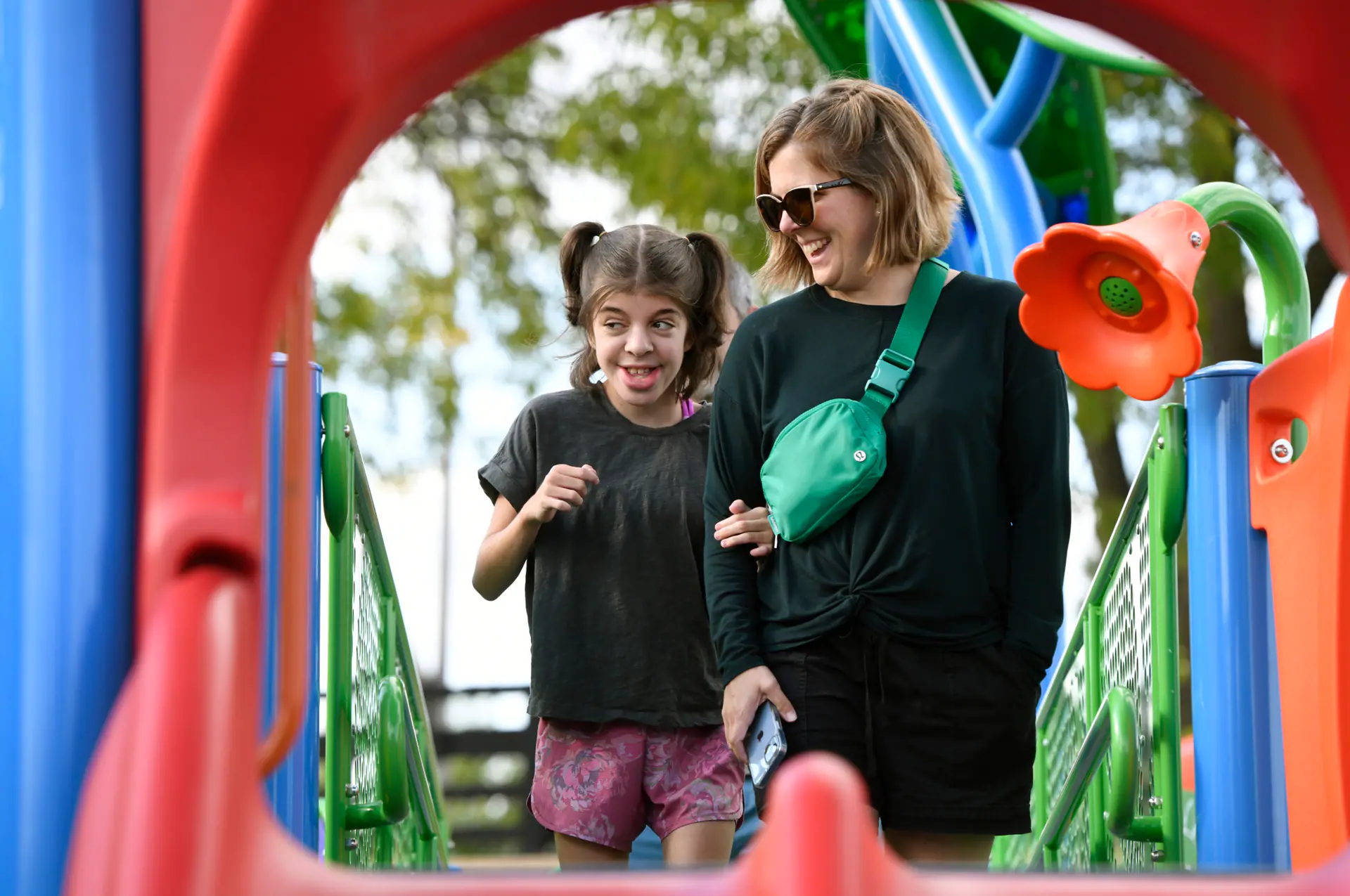 Children and adults using Play Michigan playground features