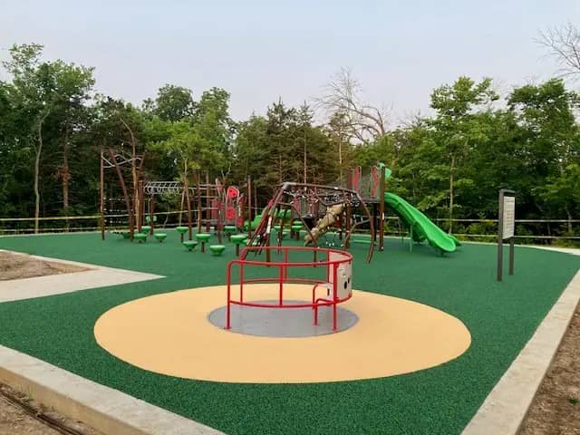 Inclusive playground at Binder Park with modern play structure and rubber surfacing in Jefferson City