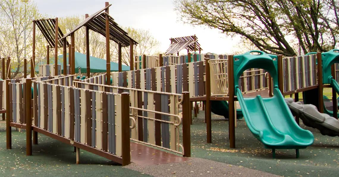 Inclusive play structure with slides at Patricia LeBlanc Park