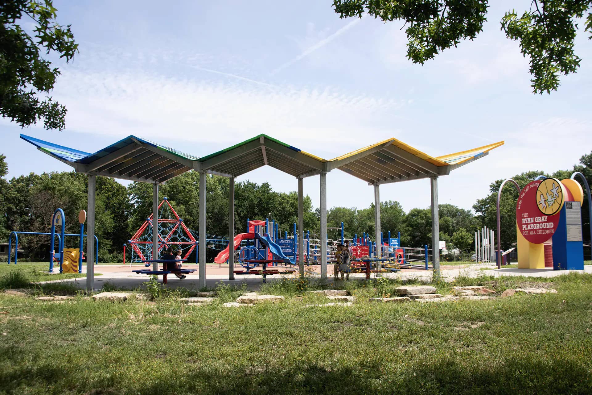 Colorful shade pavilion next to the Ryan Gray Playground for All Children in Lawrence