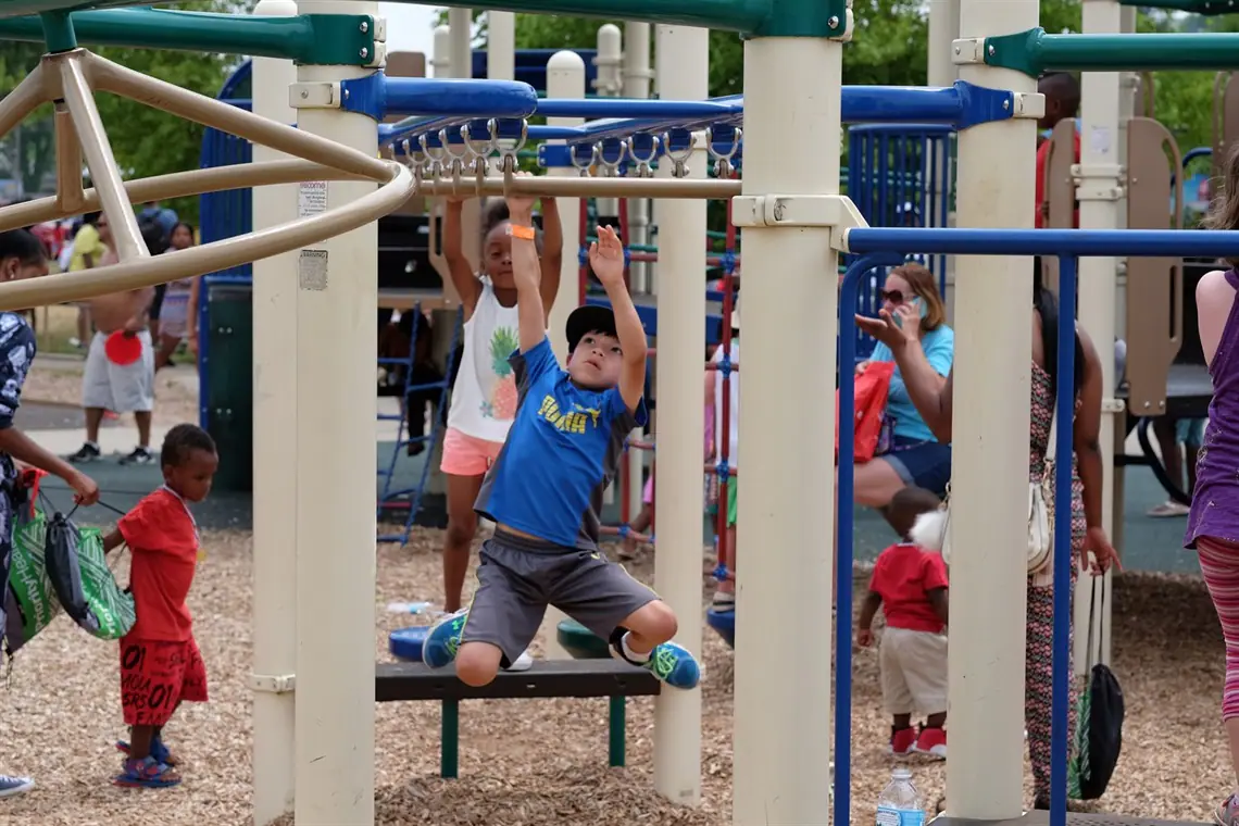 Children playing at the boundless playground at Upjohn Park in Kalamazoo