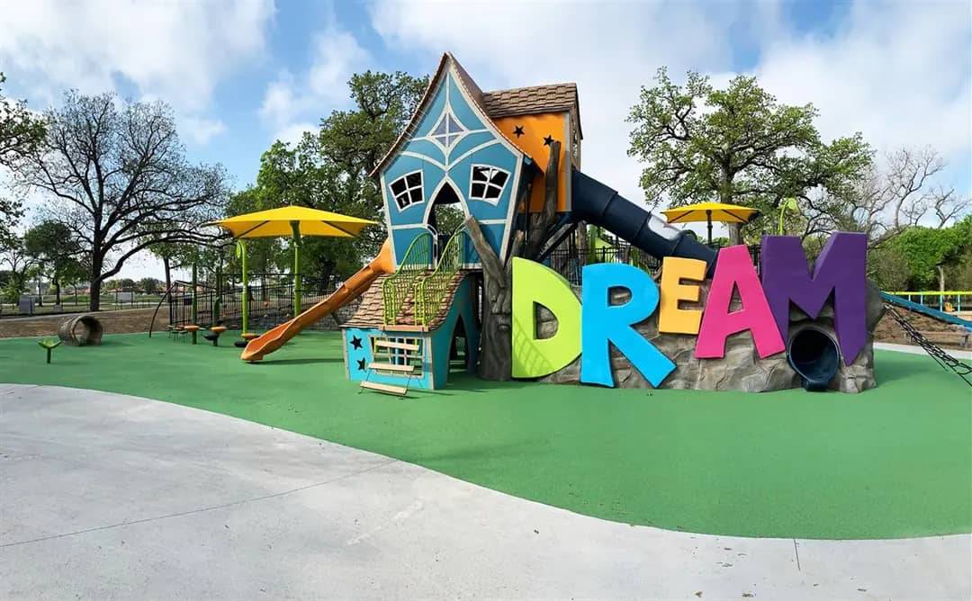 Wide view of Fort Worth Dream Park inclusive playground in Trinity Park