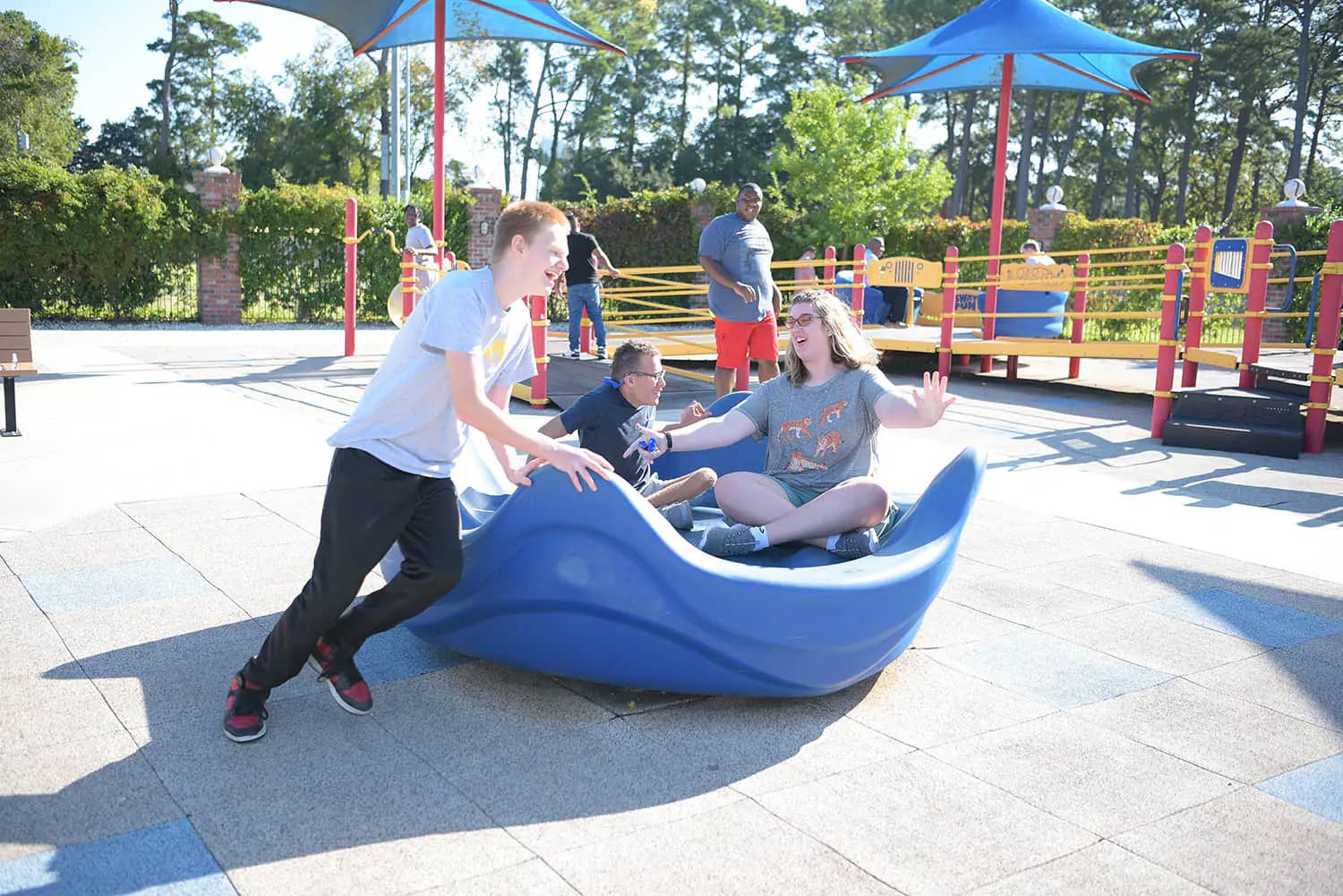 Children using an inclusive spinning feature at All-Star Park