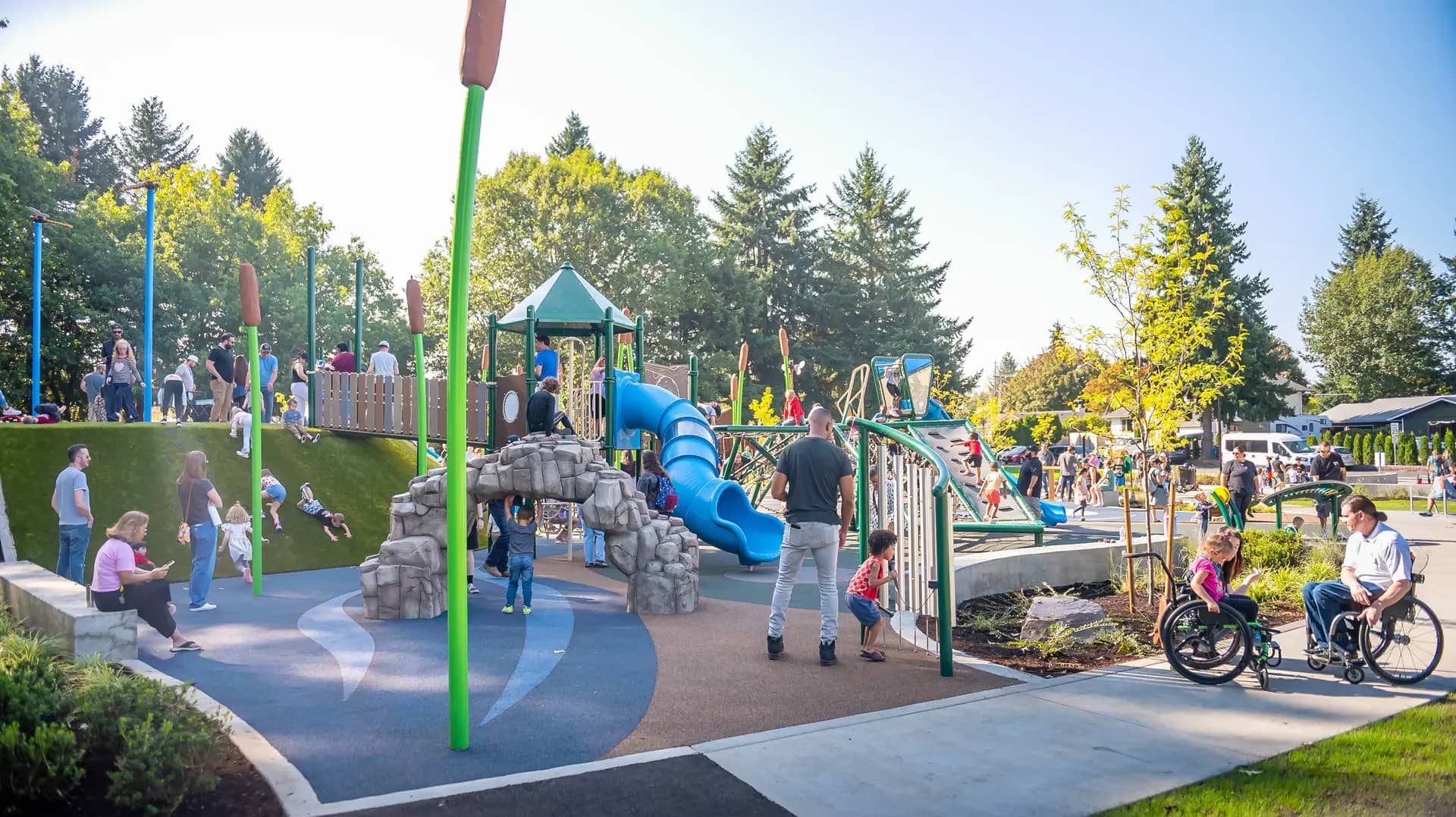 Children playing on the wetlands-themed inclusive playground at Oakbrook Park in Vancouver.